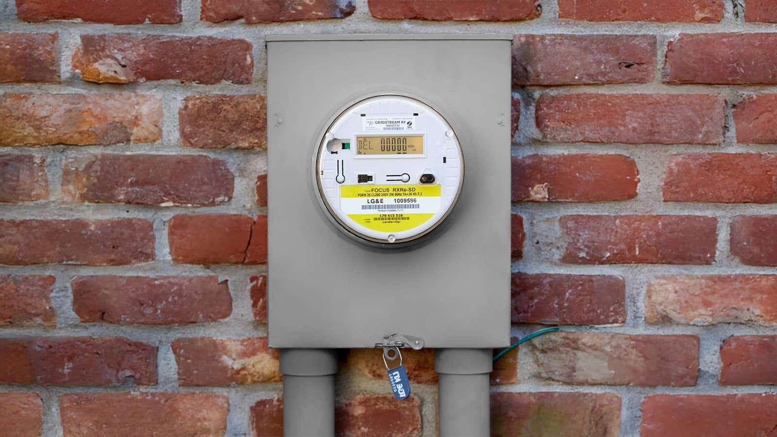 An electrical meter on a brick wall